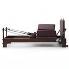 Pilates Reformer Studio Prestige, rovere finitura noce, rivestimento bordeaux – vista laterale con sitting box